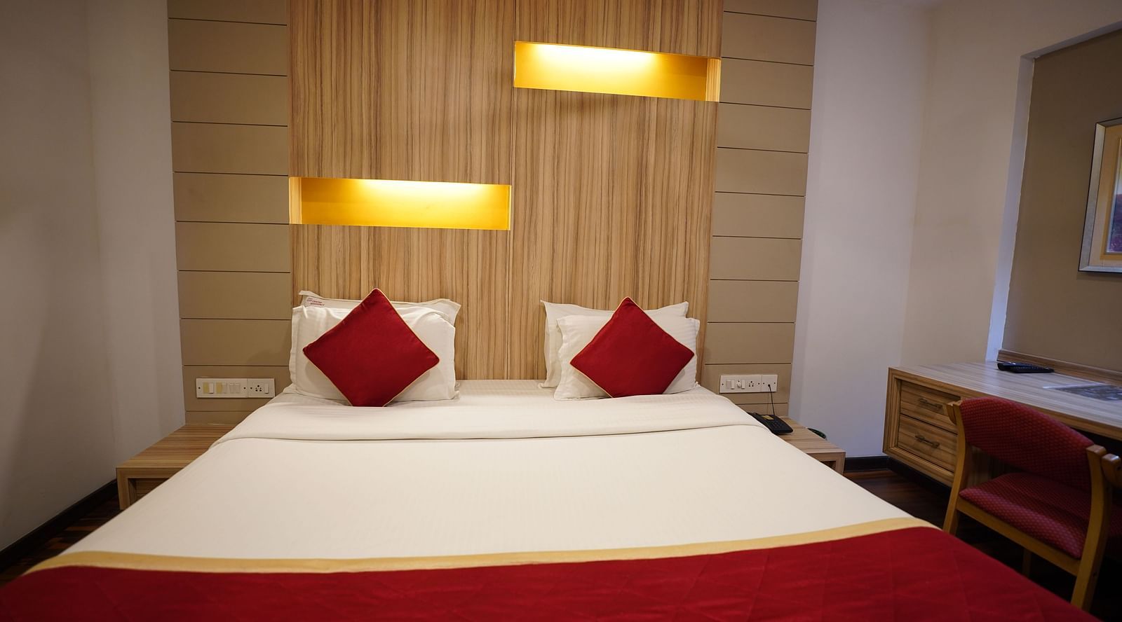an image of a deluxe bedroom with a study table and a chair at  City Centre Residency, Bangalore