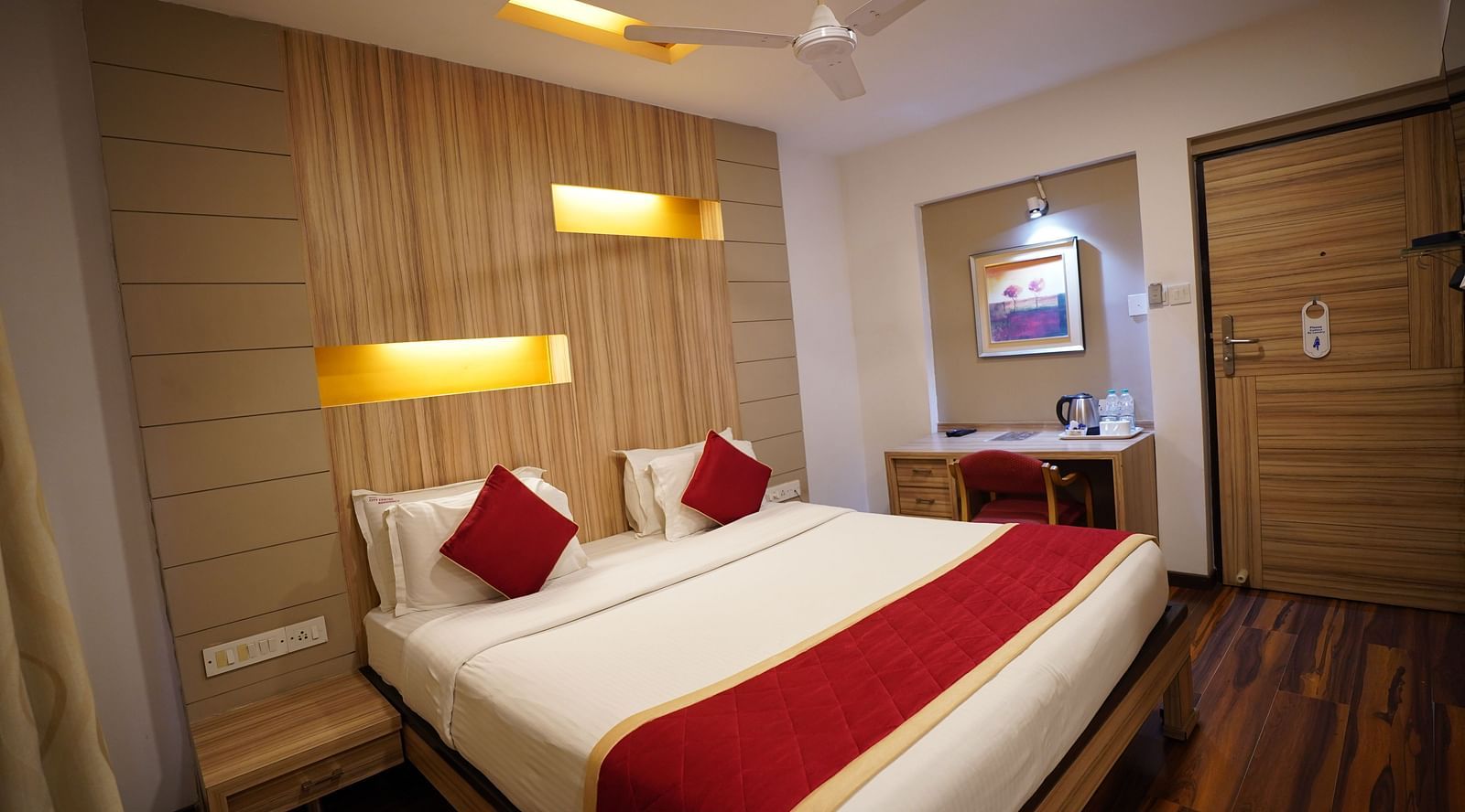 an image of a deluxe bedroom with a fan hanging from the ceiling at City Centre Residency