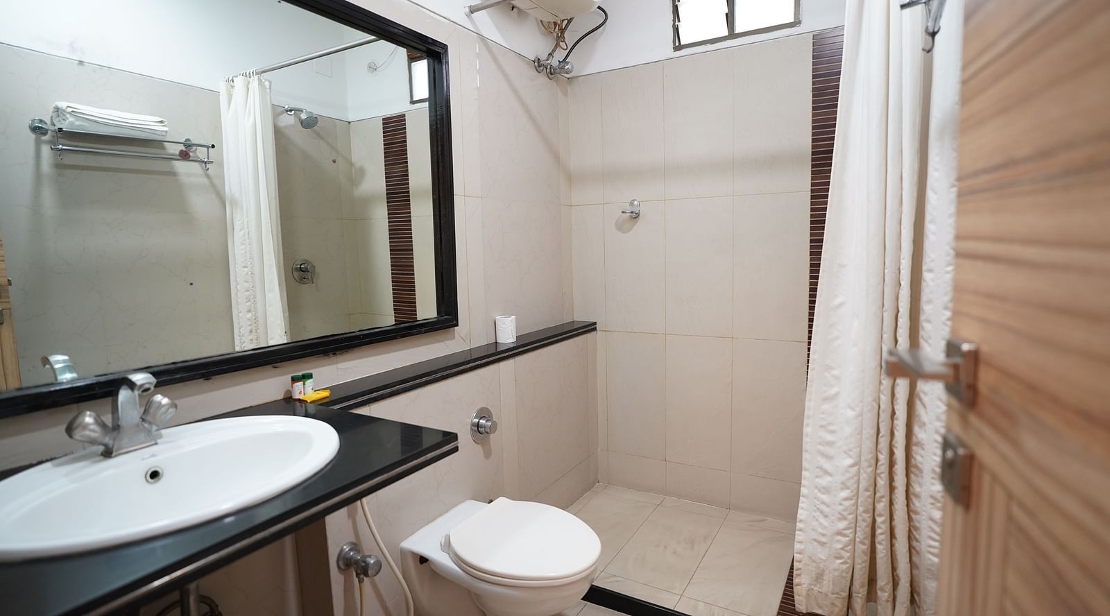 an image of a bathroom with a wash basin and a mirror at  City Centre Residency, Bangalore