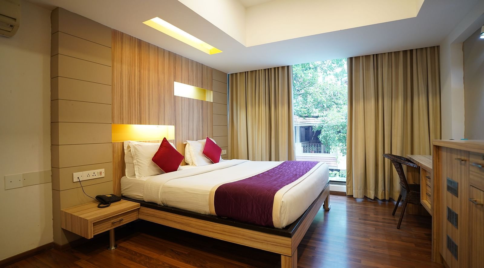 an image of a bed in a suite with a huge window at  City Centre Residency, Bangalore
