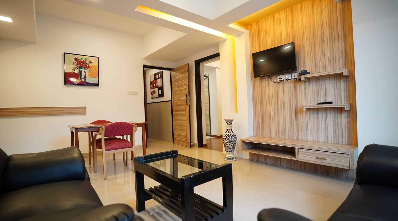 an image of a living space with a television in a suite at  City Centre Residency, Bangalore