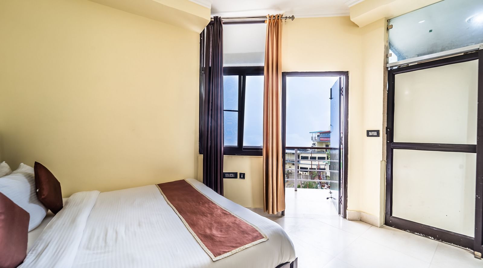 a room at Flutter Hotels & Resorts featuring a bed and a wardrobe