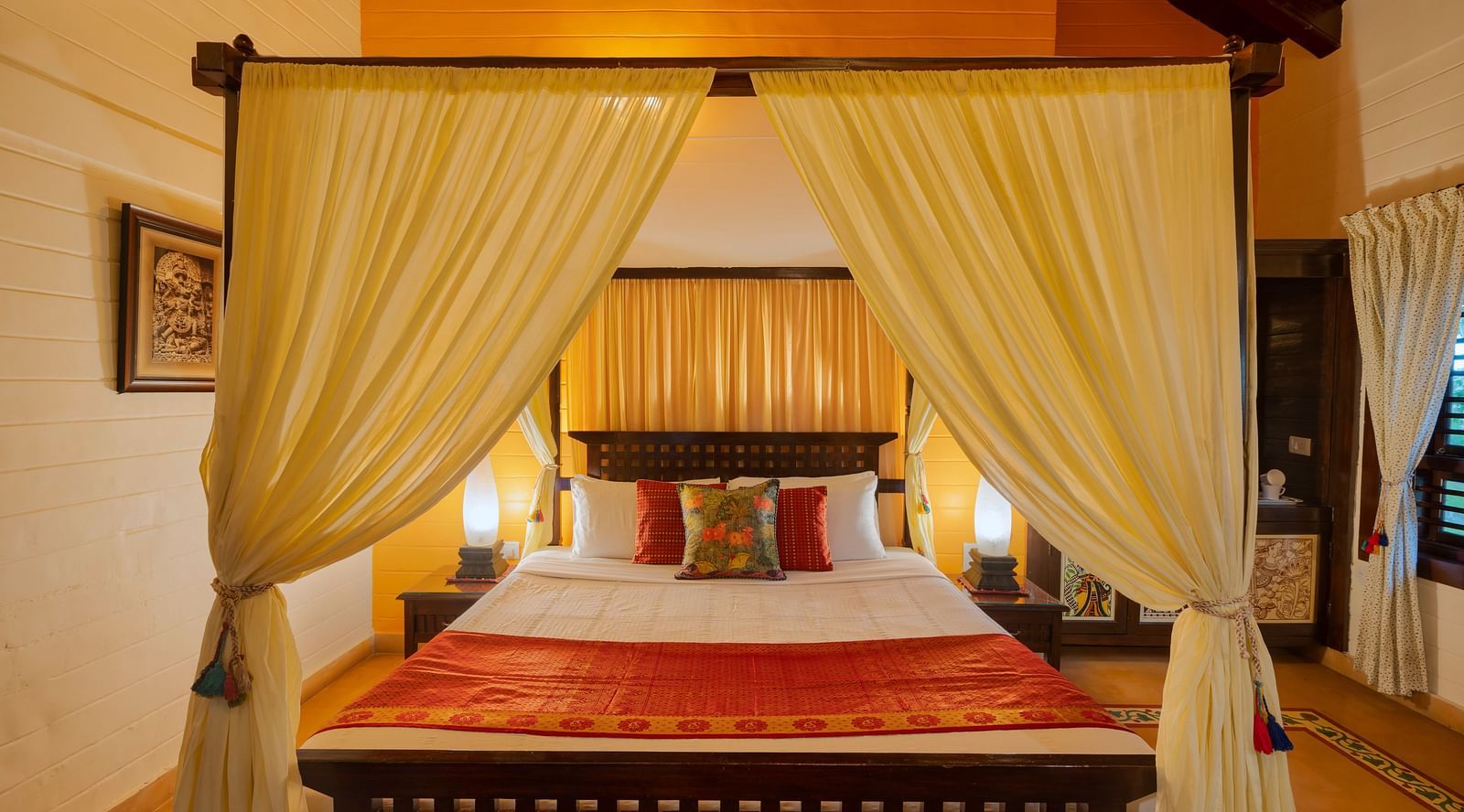 image of a comfortable king size bed at the heritage superior cottage at hoysala village resort in hassan