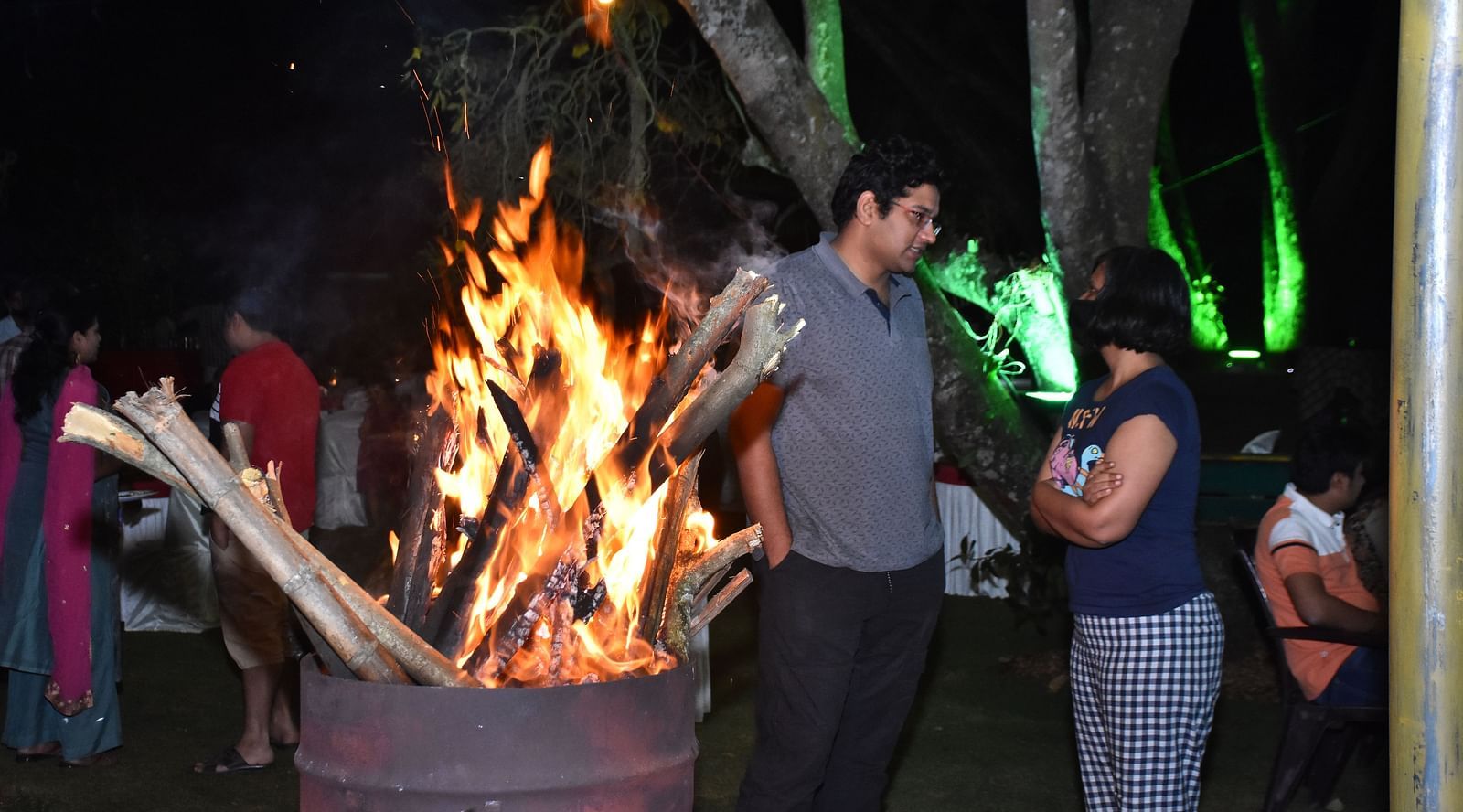 image of a bright camp fire at the garden restaurant in hoysala village resort, hassan