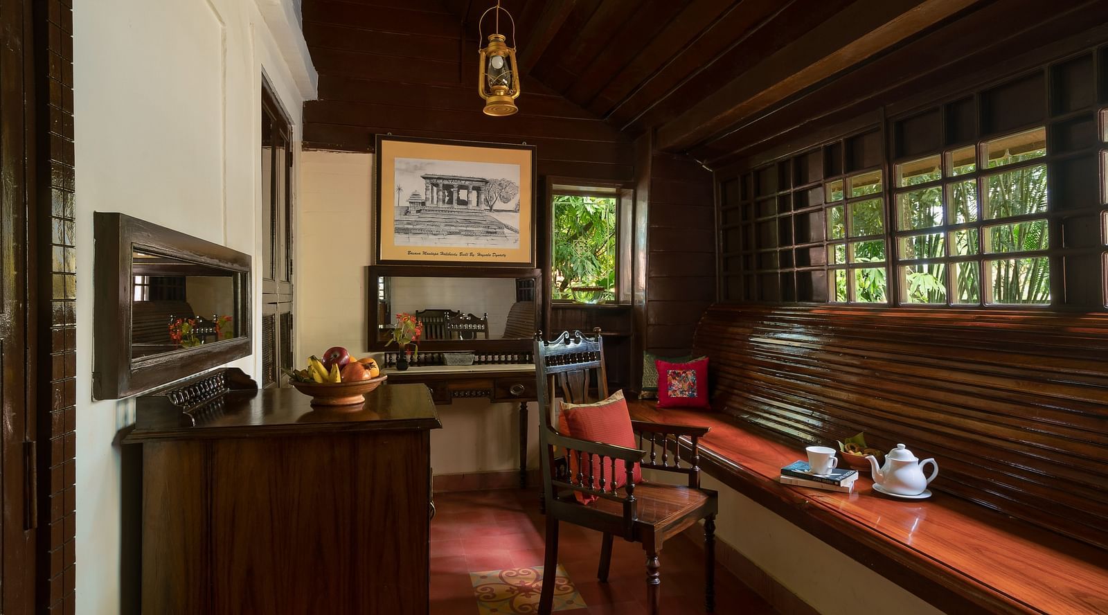 An image of a seating area which has a sofa with cushions and bolster pillows - Hoysala Village Resort, Hassan