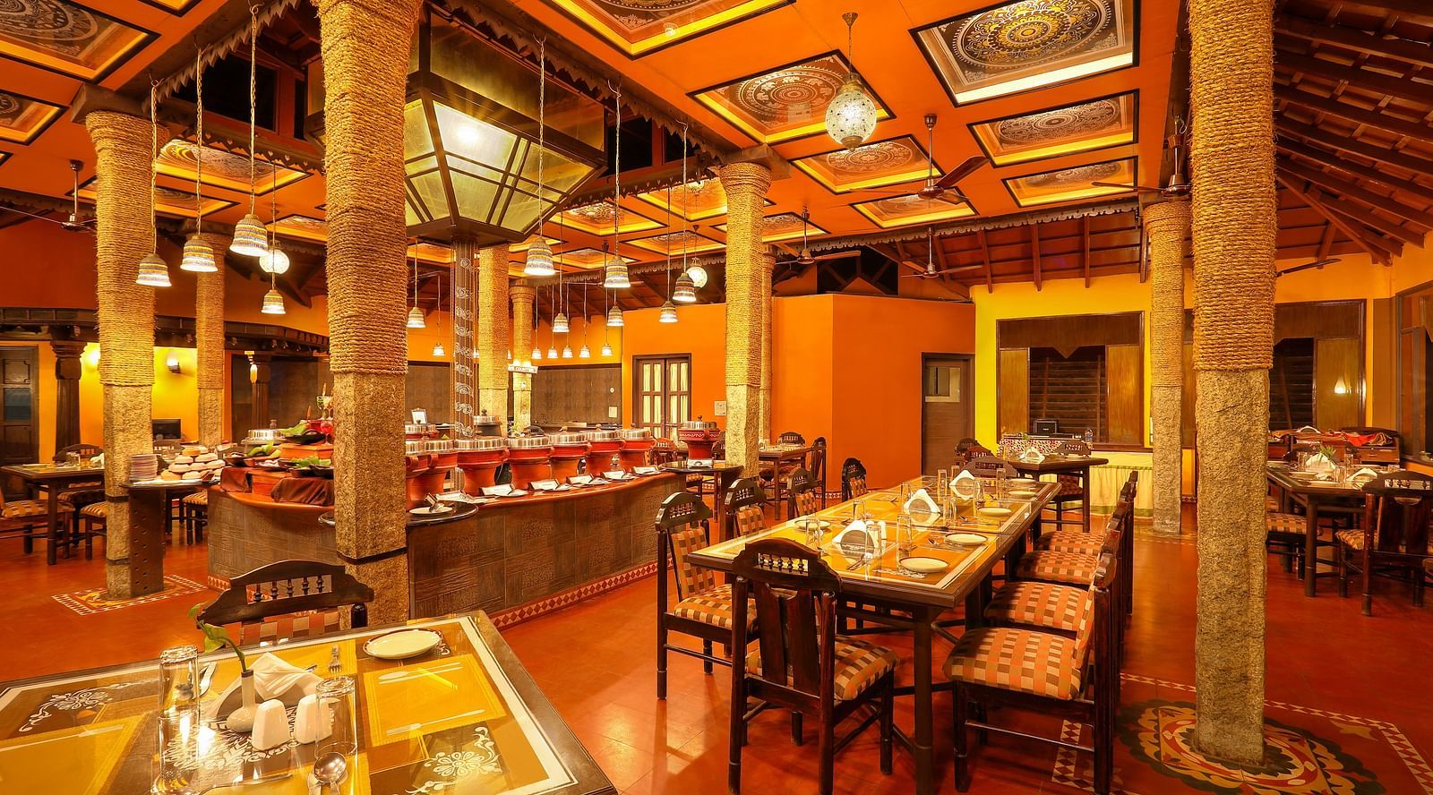 brightly lit Kokam Restaurant at Hoysala Village Resort, Hassan
