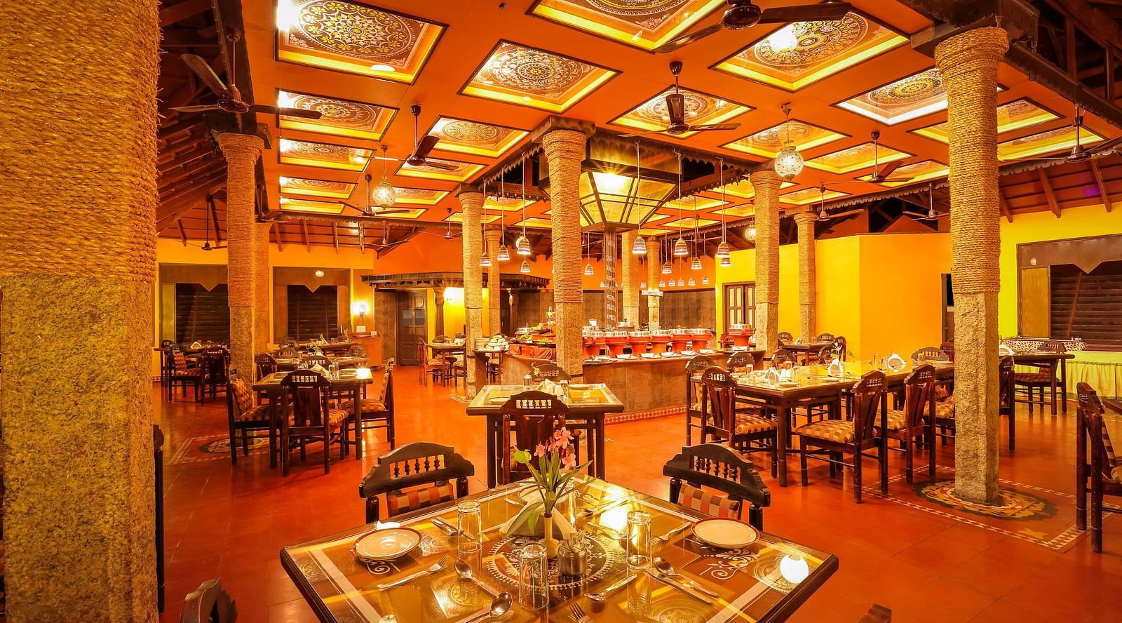brightly lit Kokam Restaurant at Hoysala Village Resort, Hassan