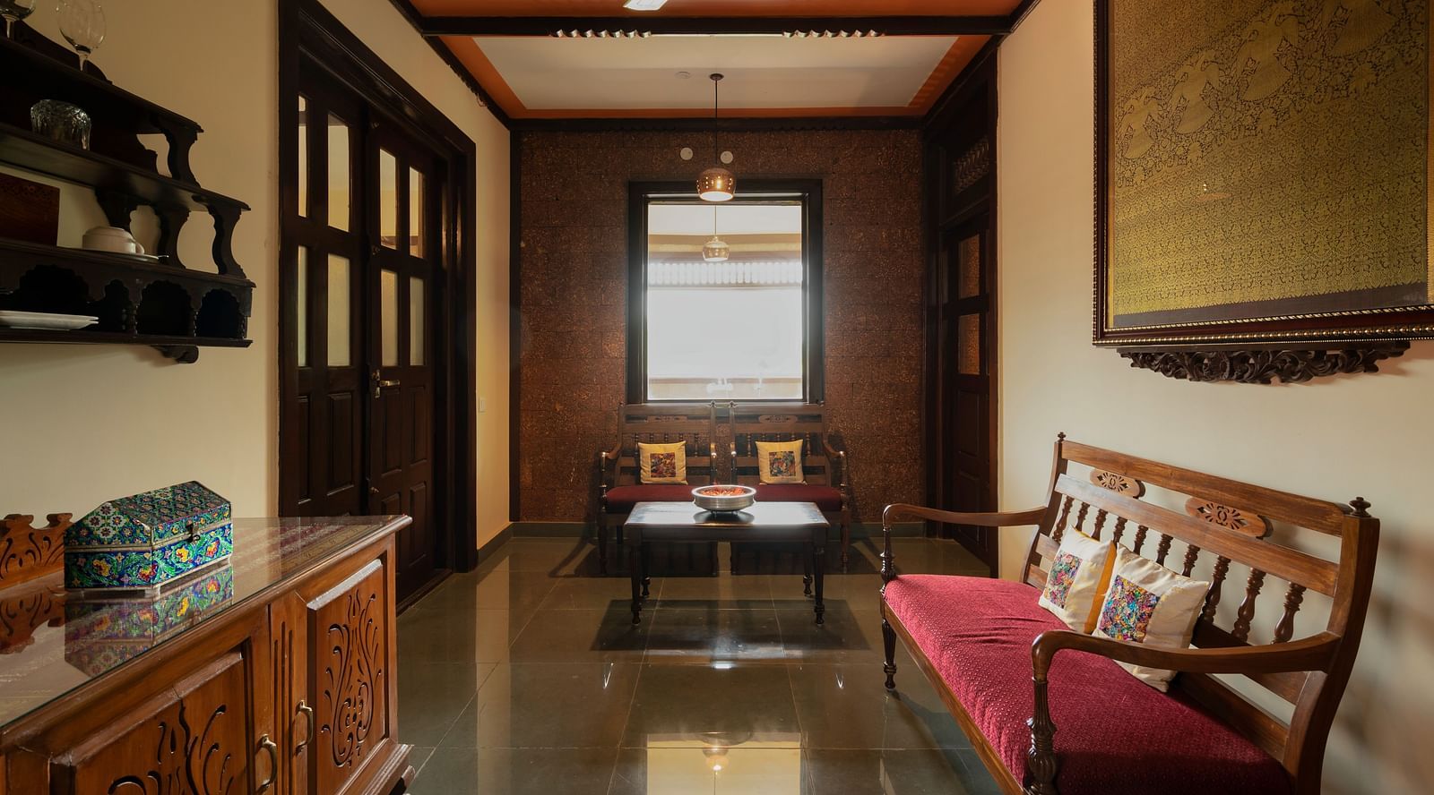 An image of a seating area which also has a cabinet, tables, and other wooden furnishes - Hoysala Village Resort, Hassan