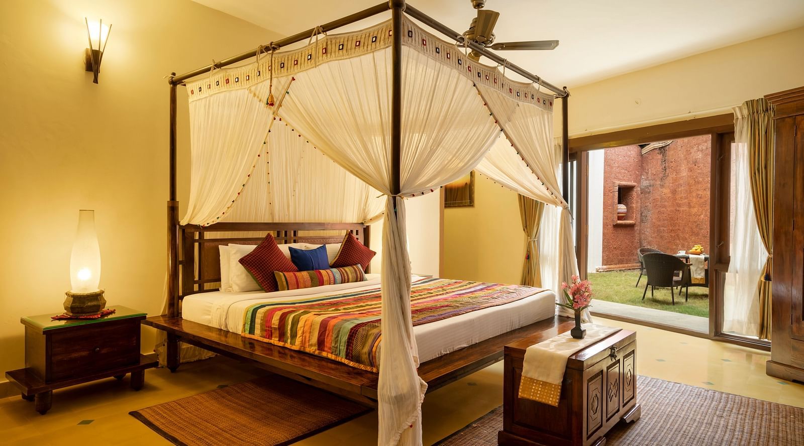 image of a bedroom featuring a lawn outside the luxury jacuzzi villa at hoysala village resort in hassan