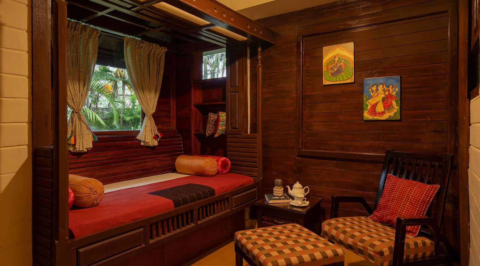An image of a sitting area with wooden chairs and tables - Hoysala Village Resort, Hassan