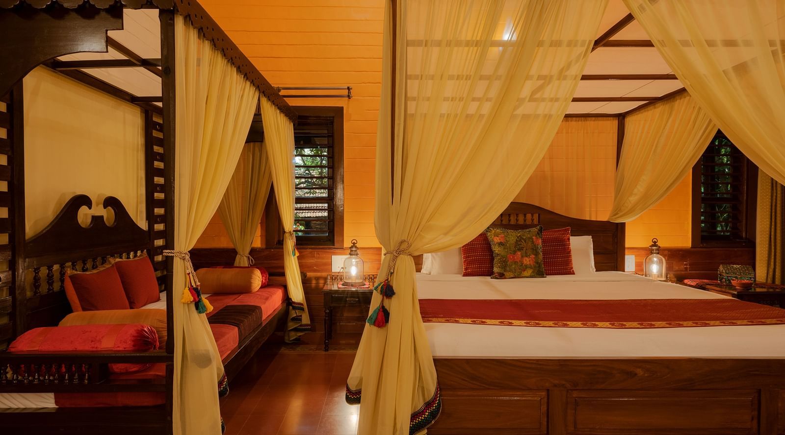 An image of a poster twin bed in a wooden furnished room - Hoysala Village Resort, Hassan