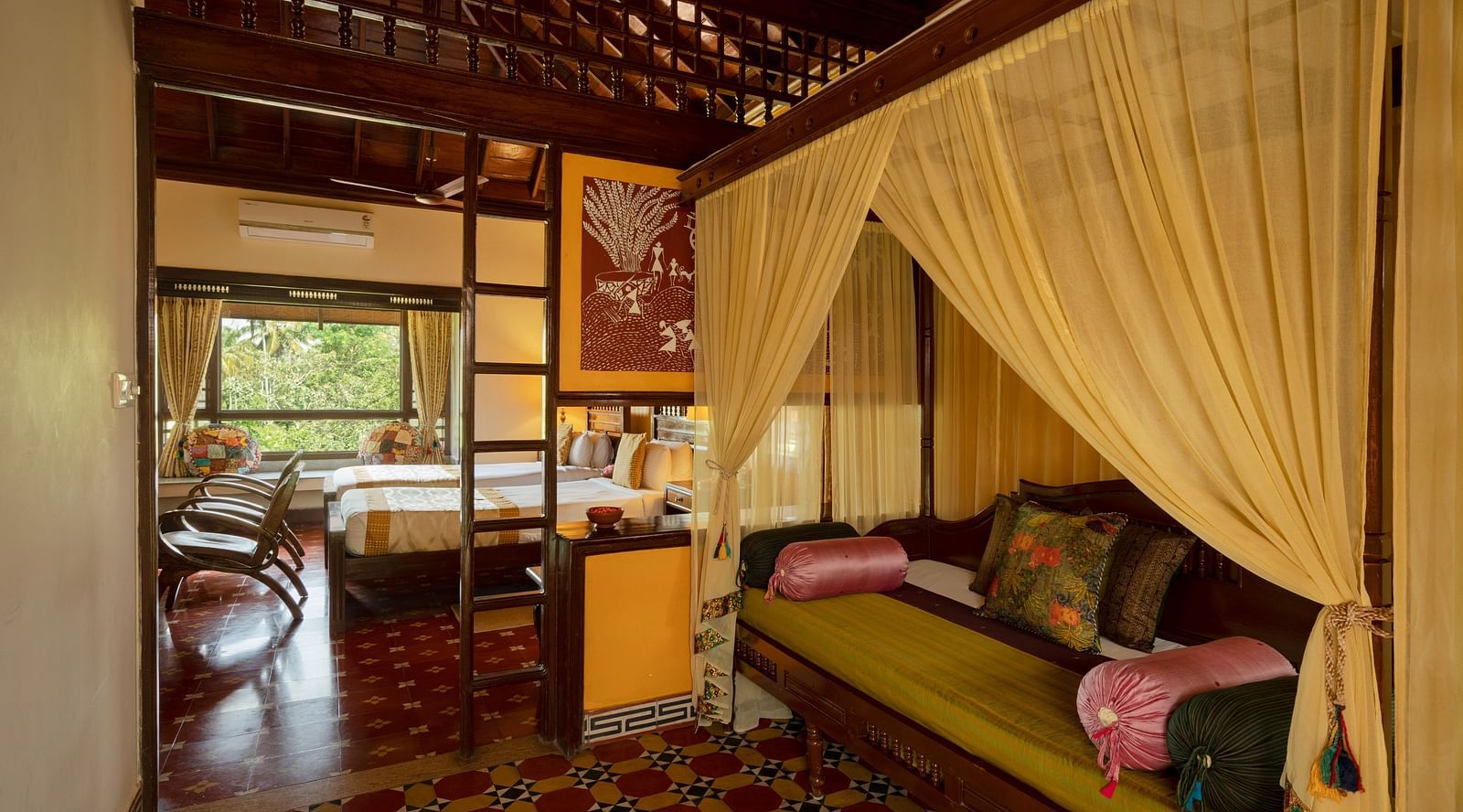 An image of a huge bedroom with poster beds, sofa, chairs, and other wooden furnishings - Hoysala Village Resort, Hassan