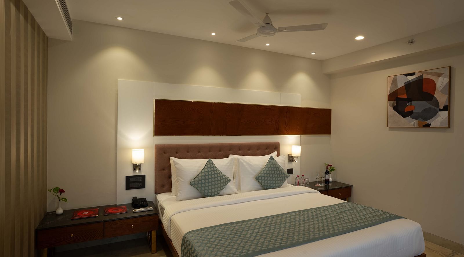 Club Room with a large double bed with decorative amenities artistically arranged at Inde Signature Jaipur.