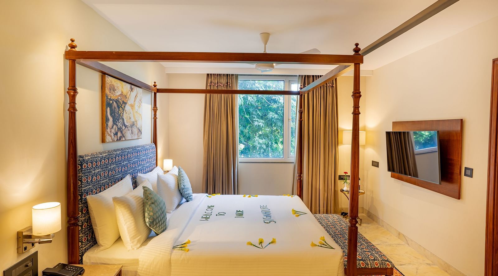 Spacious Suite with double bed, wall mounted television and big windows at Inde Signature Jaipur