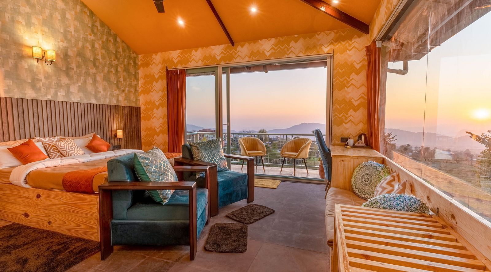 A room with a double bed and large panoramic windows at Infinitea Retreat Bir