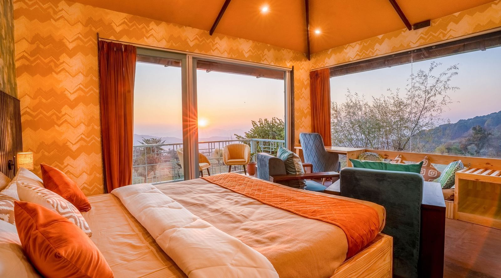 A room with a double bed and sunset views of the valley
