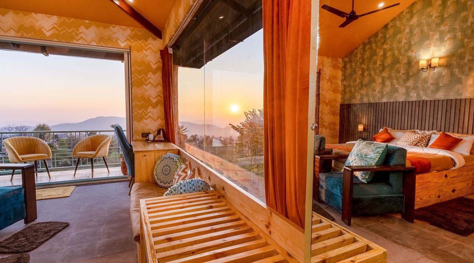 A room with a double bed and large panoramic windows at Infinitea Retreat Bir