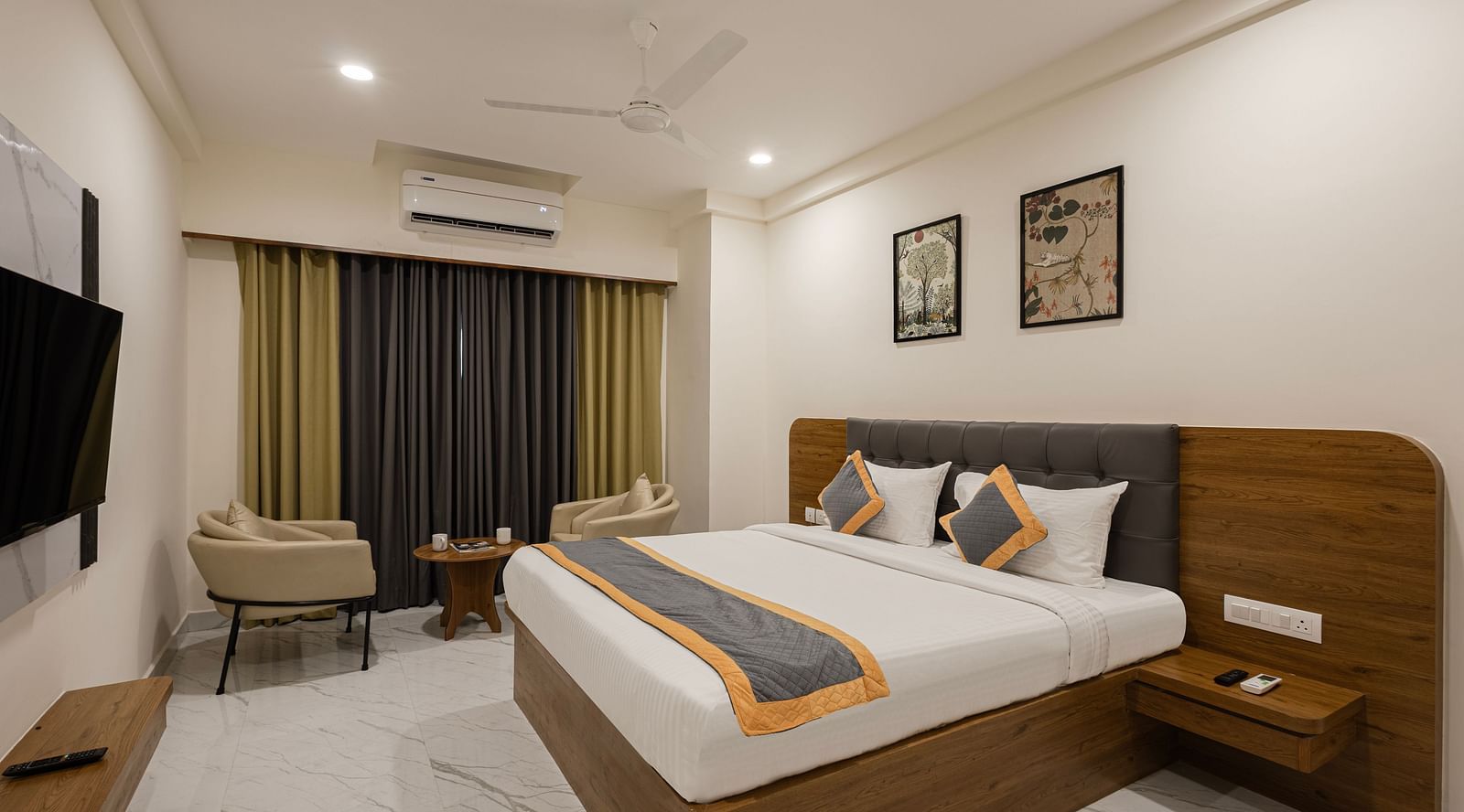 Comfortable room with bright curtains, bed, and wall art at Lemonridge Hotels, IDPL Balanagar.