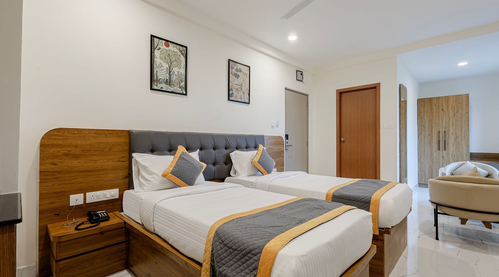 Neatly arranged double bed and workstation in a guest room at Lemonridge Hotels, IDPL Balanagar.