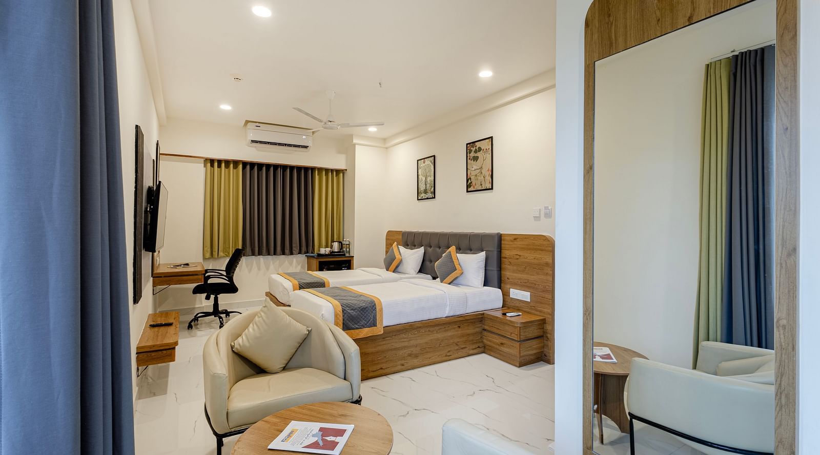 Stylish comfort twin room with soft lighting, seating area, and large bed at Lemonridge Hotels, IDPL Balanagar.