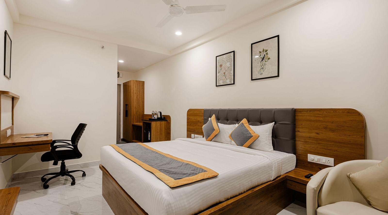 A corner view of cosy bedroom with sleek interiors at Lemonridge Hotels, IDPL Balanagar