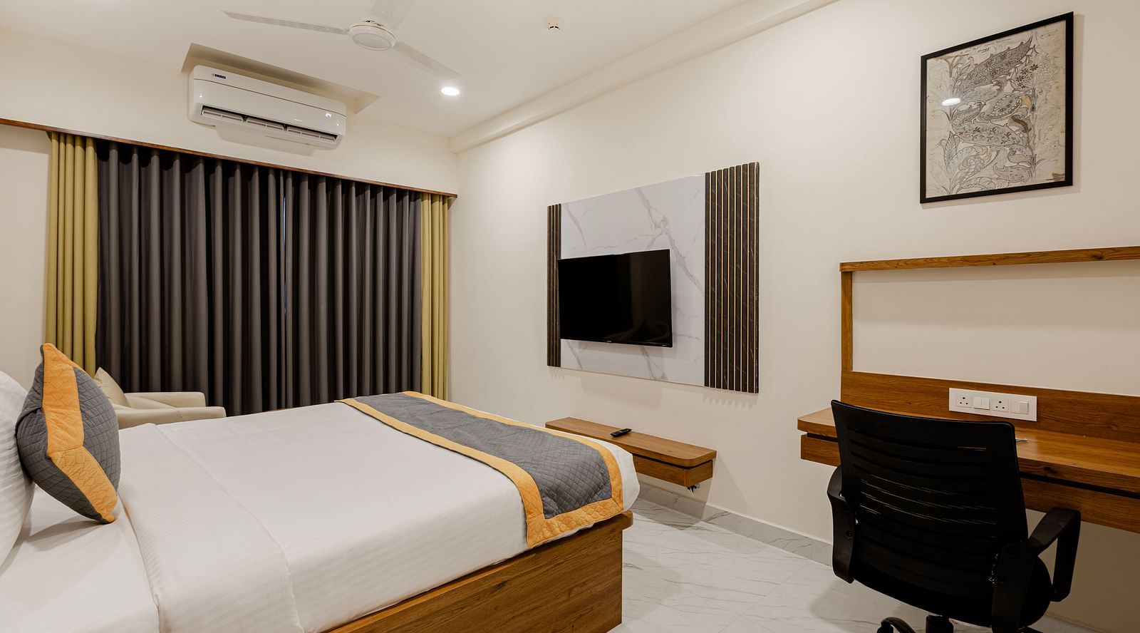 Well-lit cosy king room with king-size bed and wood-finish furniture at Lemonridge Hotels, IDPL Balanagar