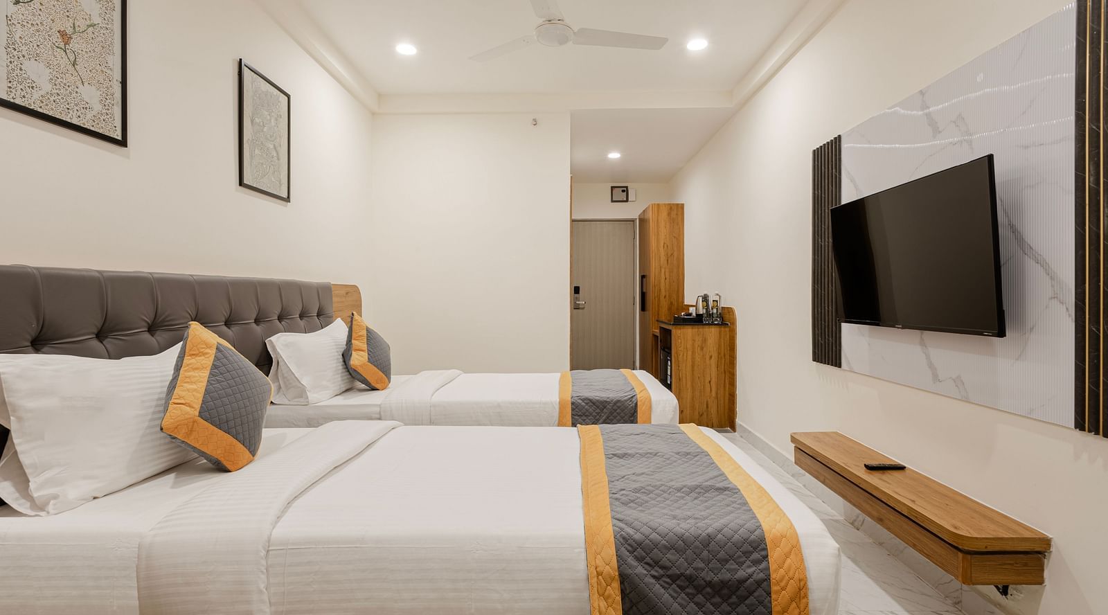 Modern twin size room with cosy seating at Lemonridge Hotels, IDPL Balanagar