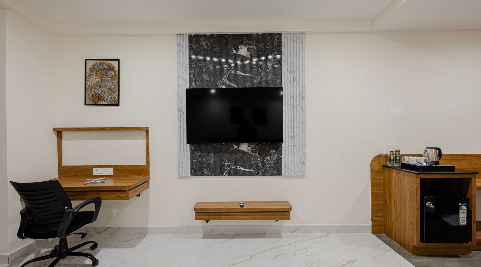 Premium room with flat screen TV, writing desk, and seating area at Lemonridge Hotels, IDPL Balanagar.