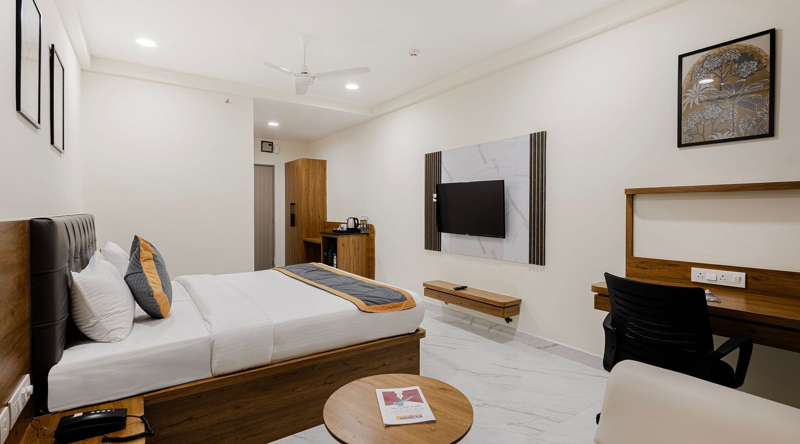 Premium room featuring cosy seating, writing desk, and double bed at Lemonridge Hotels, IDPL Balanagar.