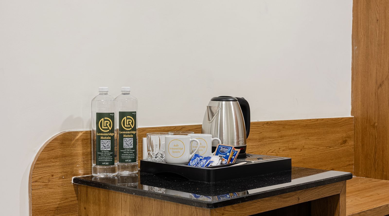 In-room tea and coffee setup with bottled water at Lemonridge Hotels, IDPL Balanagar.