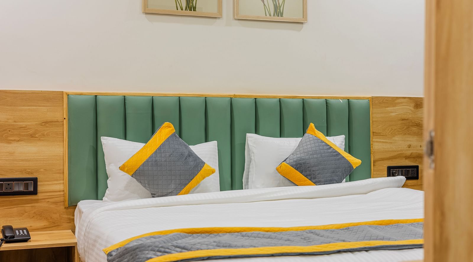 Lemonridge Hotels, KPHB | Close-up of a bed with decorative pillows and a headboard. Comfortable and inviting.