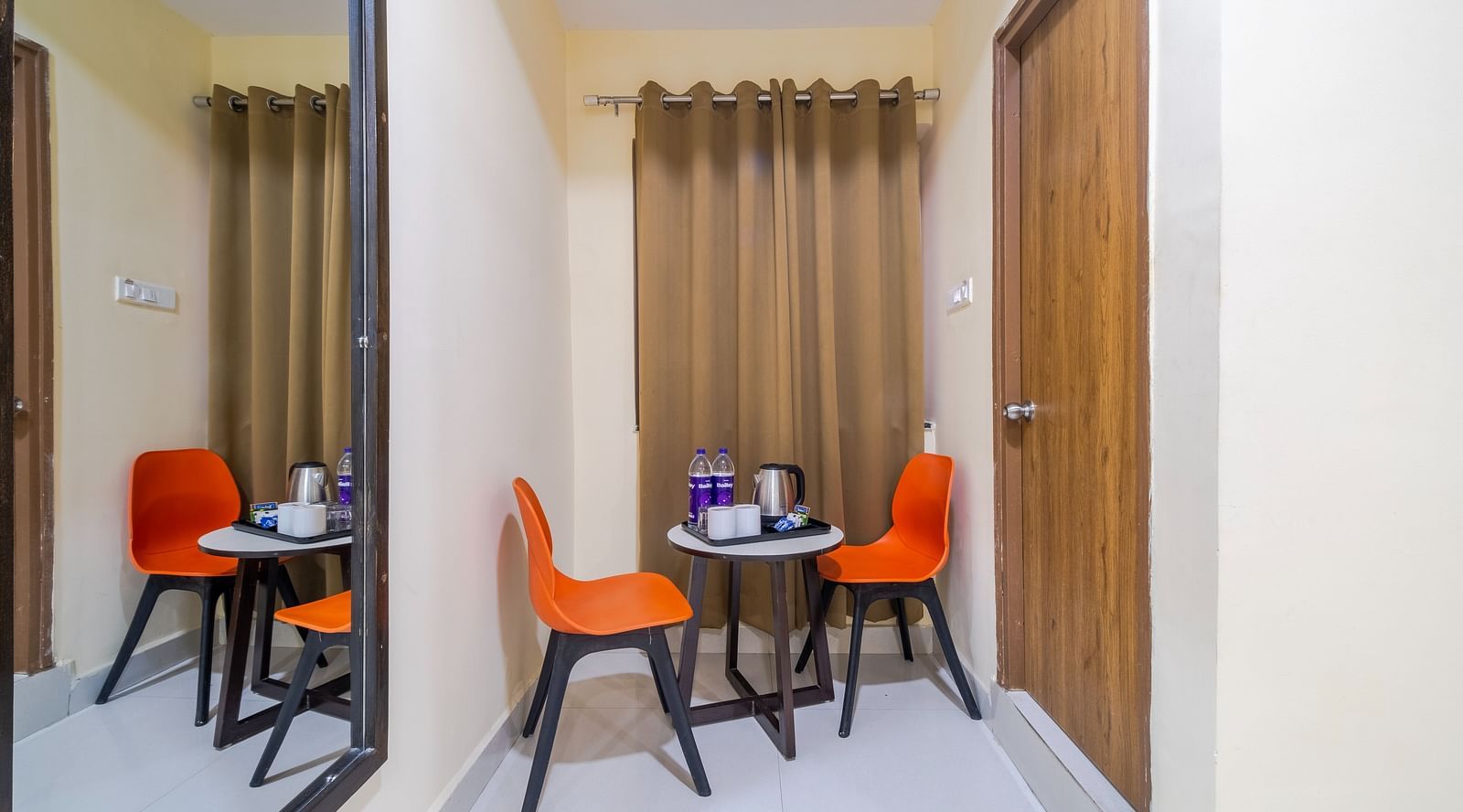 Two chairs and a table stand in the Executive room corner at Lemonridge Hotels
