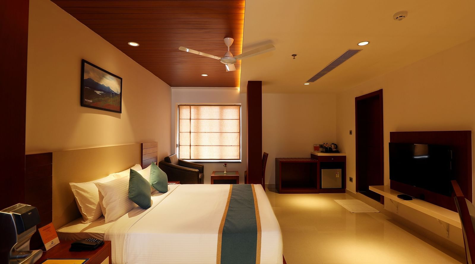 Signature Room decked with a bed and a fan hanging from the ceiling at Mesta Hotel