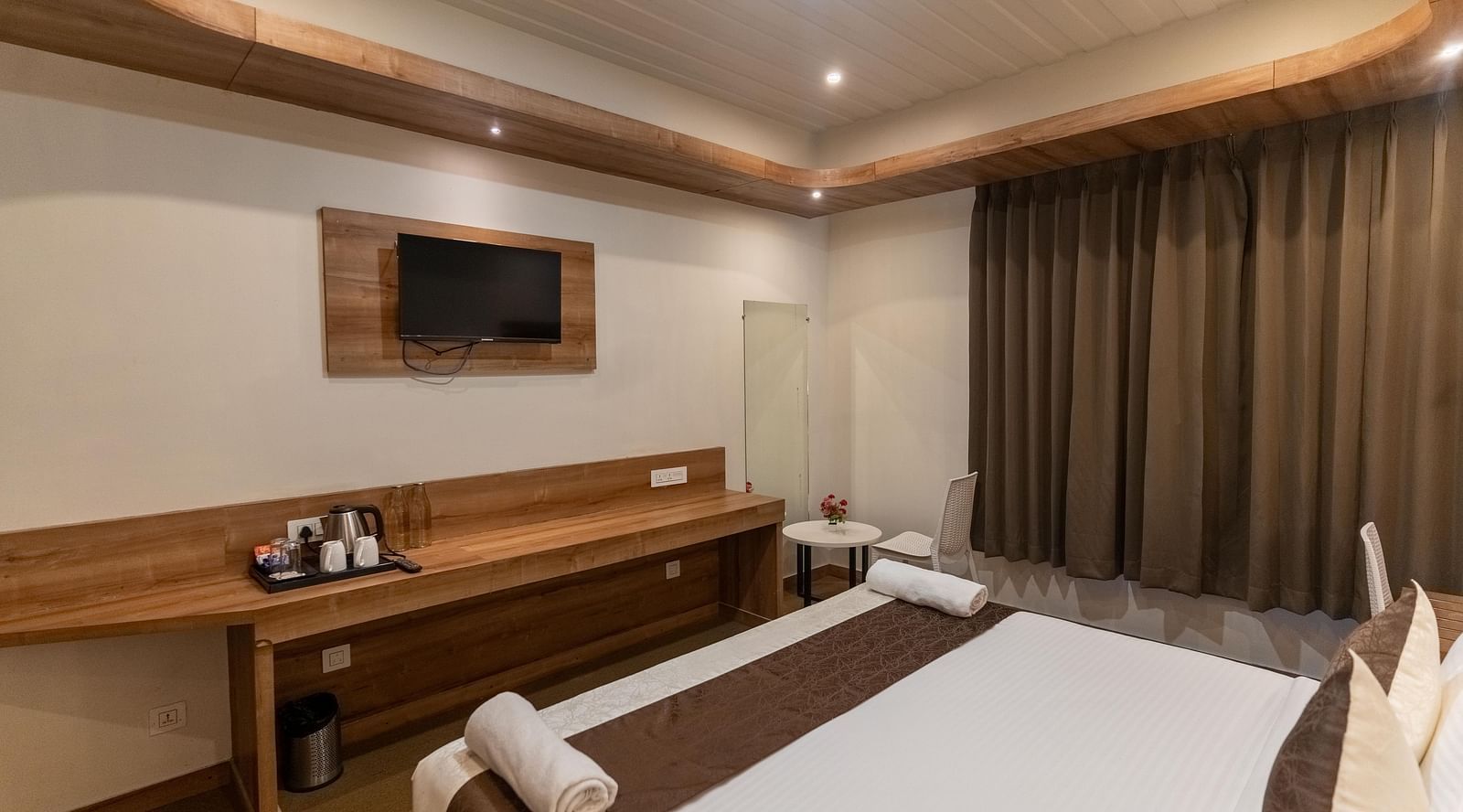 standard room with a wall mounted television at the soma hotel by avianna group, darjeeling