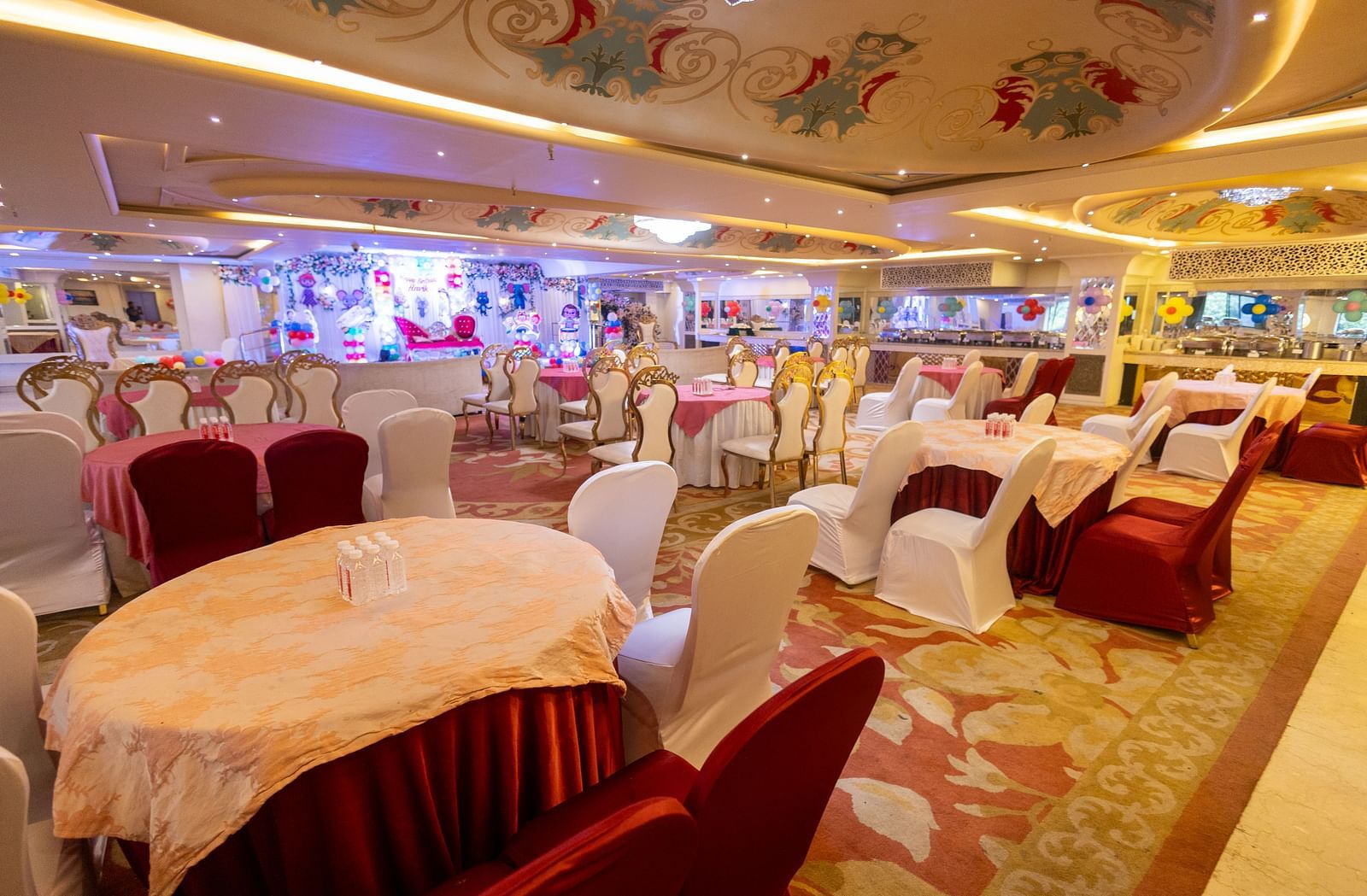 Samrat featuring round tables draped with tablecloths, some in light colours and others in a darker shade.