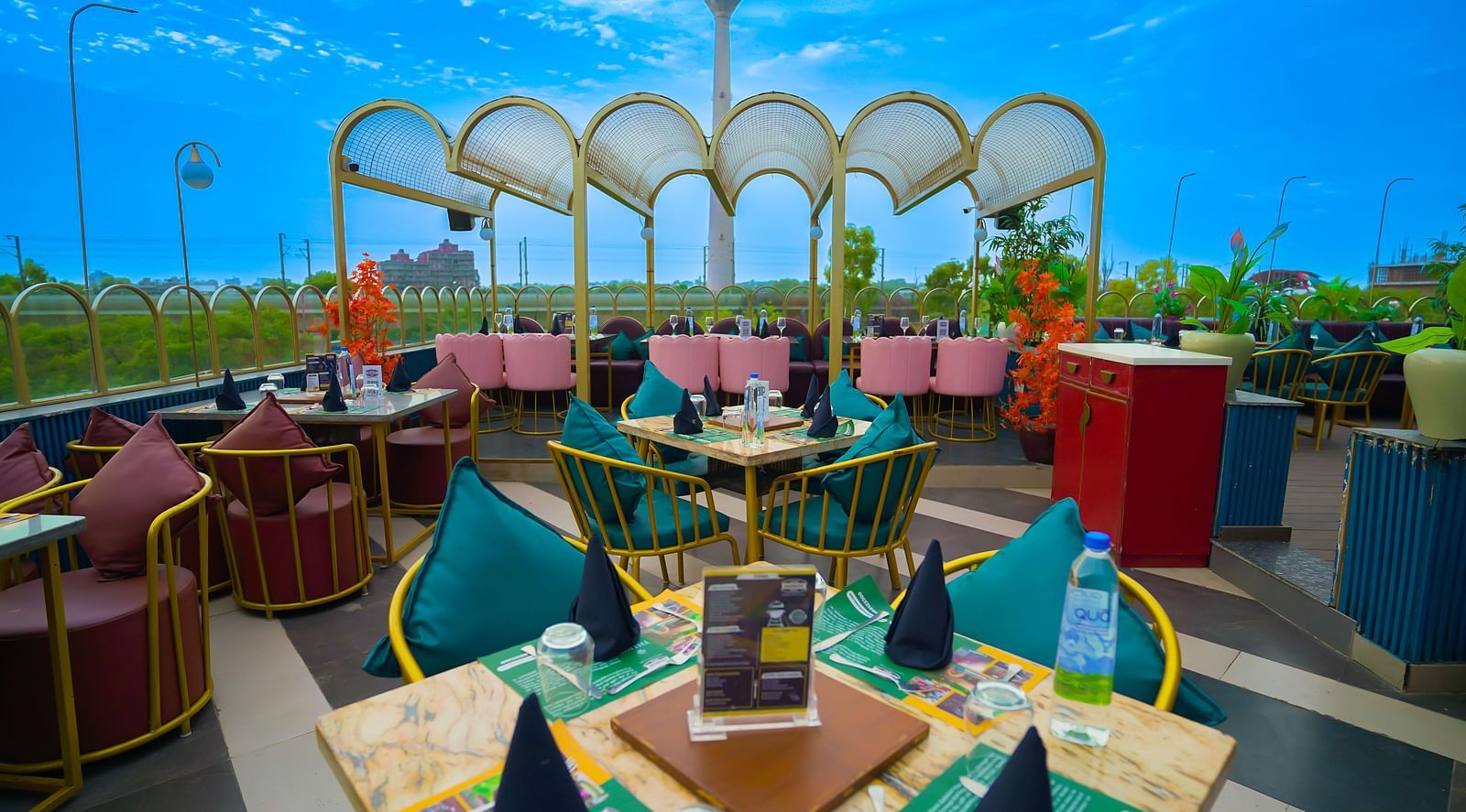 An image of a rooftop restaurant featuring chairs and tables sets at every corner - Themis Barbecue House, NSP Pitampura