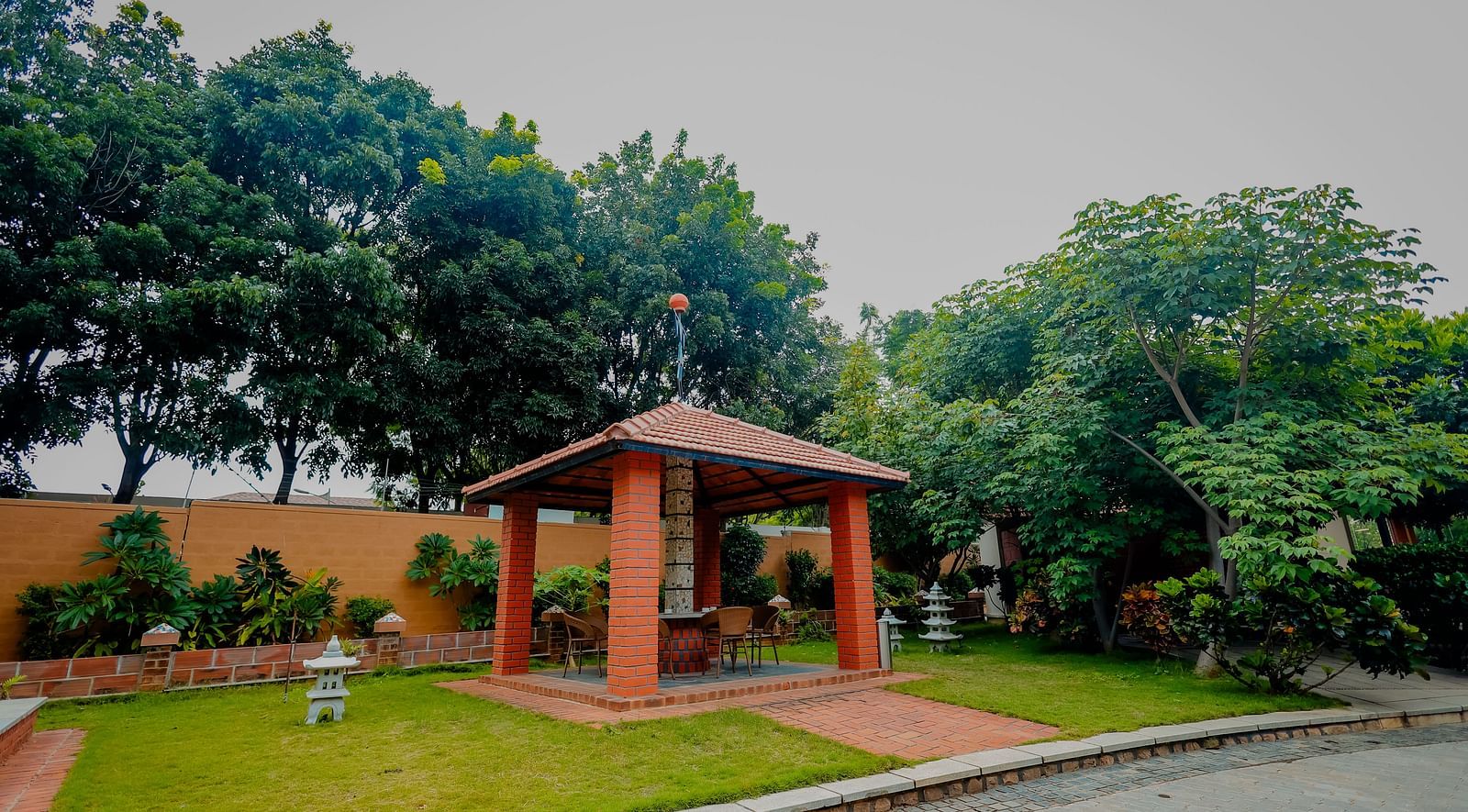 A gazebo or outdoor seating area in a garden at Nirantara Resort & Spa.