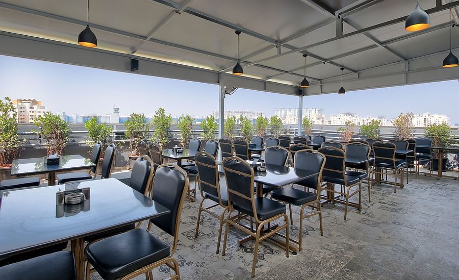 alt-text Seating arrangement inside the Restaurant in the morning - Magnus Fortune House, Magarpatta 1