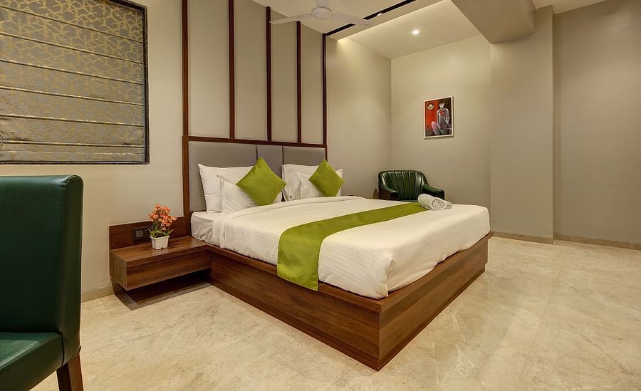 alt-text A double bed with side tables inside Luxury Suite - Fortune House, Magarpatta