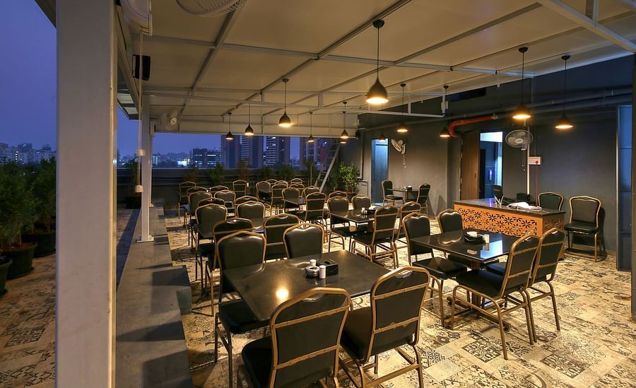alt-text Seating arrangement inside the Restaurant - Magnus Fortune House, Magarpatta 1