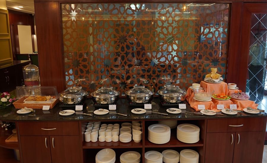 An image of buffet area at Five Elements Hotel, Jodhpur featuring pots, plates and platters, cutlery, salad, etc.