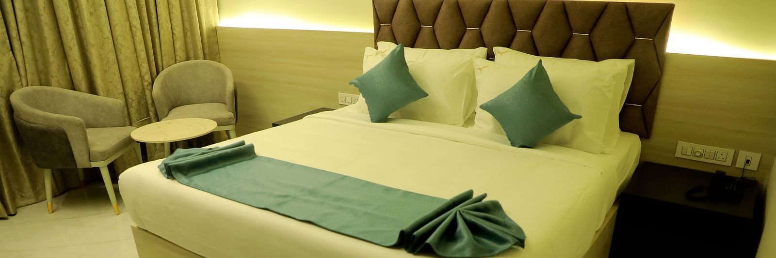 Luxurious king-size bedroom at Town Square Suites with modern decor and ambient lighting