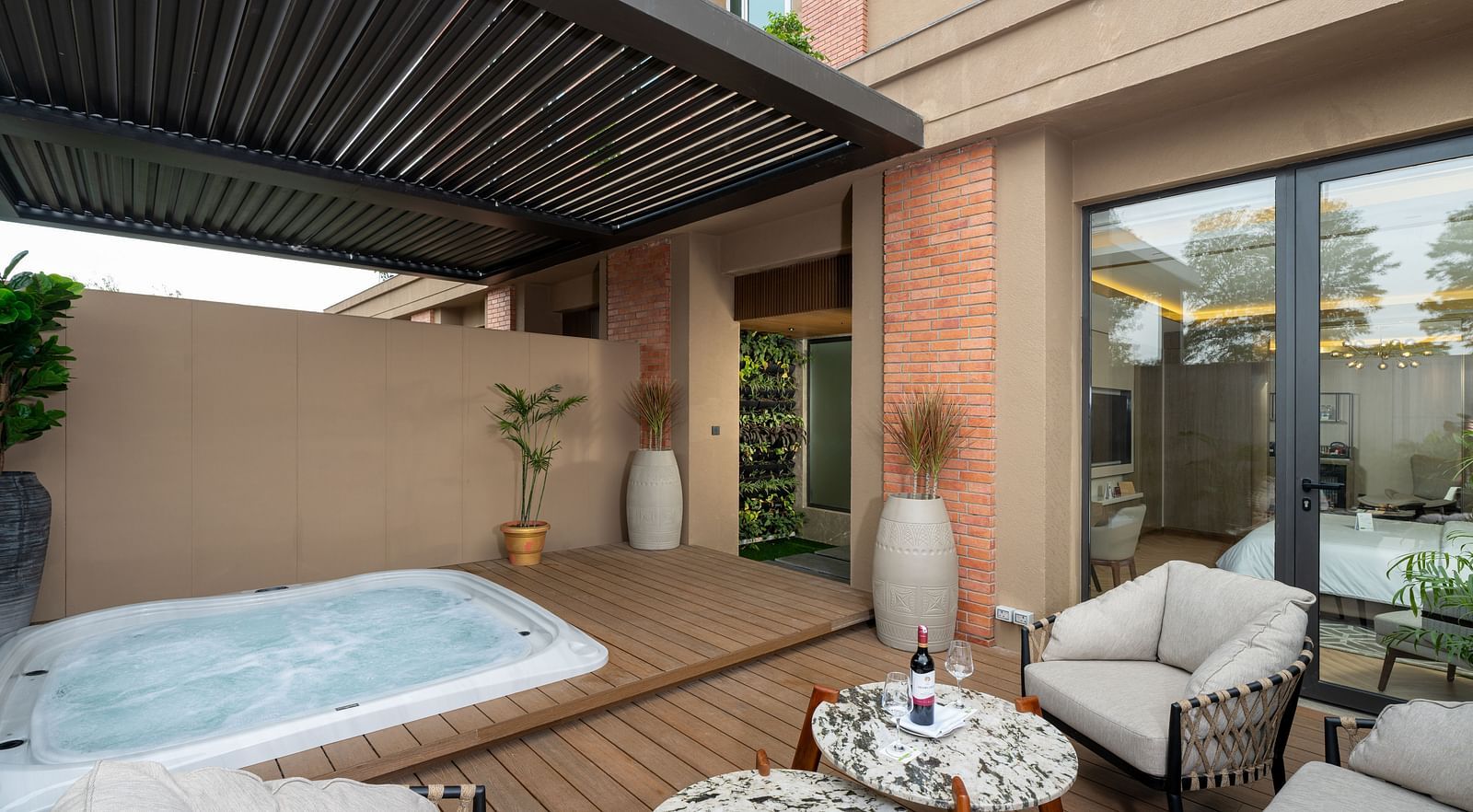 Nirvana Suite patio boasting a relaxing jacuzzi, comfortable outdoor seating, and a view of the hotel's surroundings - Nirvana Luxury Hotel, Ludhiana