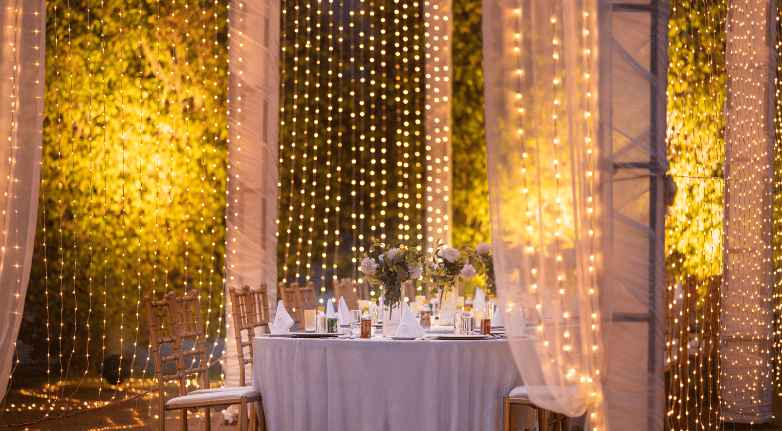 Lavish decoration at an event with a huge table surrounded by chairs at Nirvana Luxury Hotel, Ludhiana.