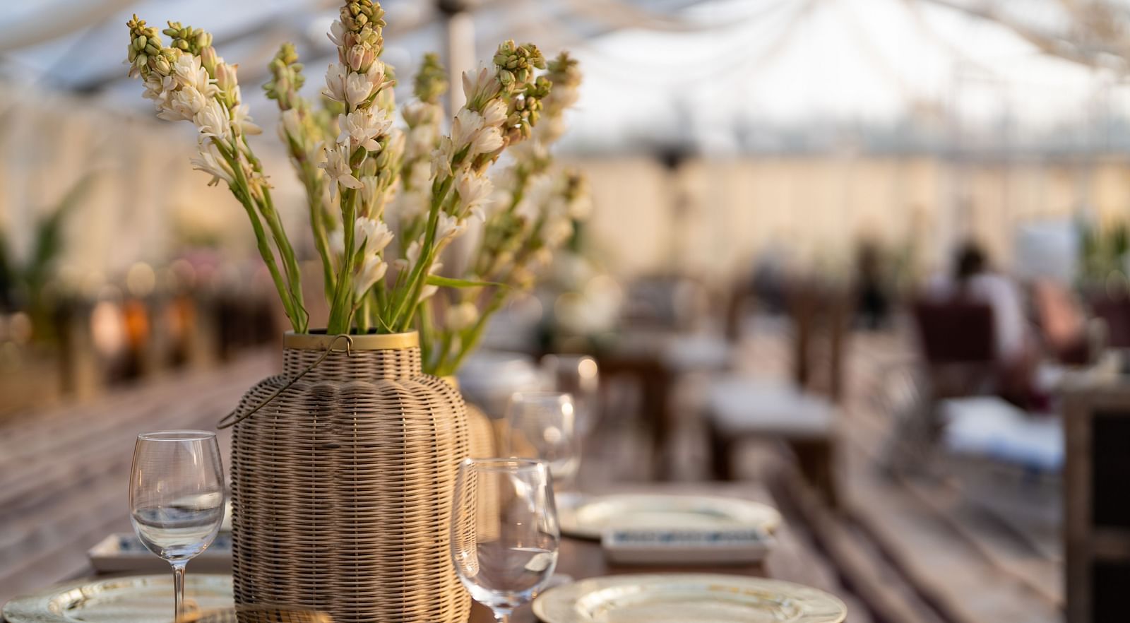 A dining arrangement with a vase setting placed on a table at Nirvana Luxury Hotel, Ludhiana.
