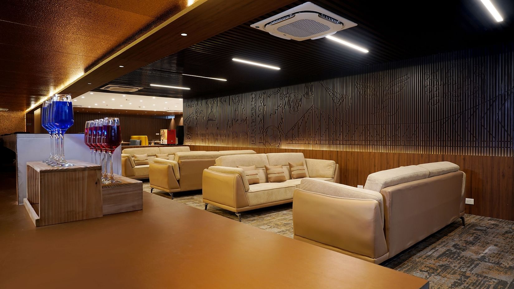 sofas and a shelf with welcome drinks in the lounge at Sarovar Portico, Kolkata Rajarhat