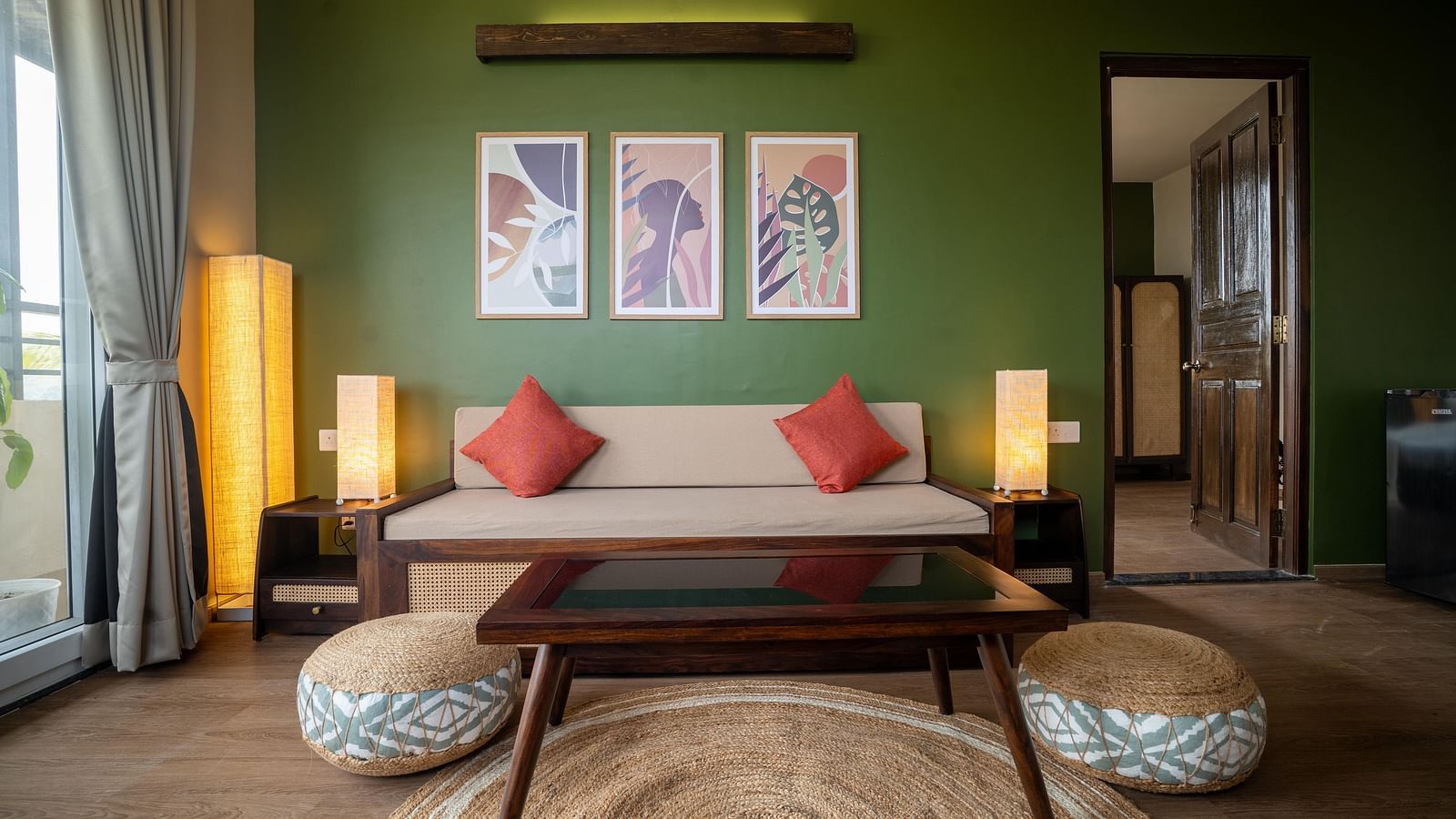Chic living area with a wooden coffee table, pouffes, and contemporary wall art at Kssemya.