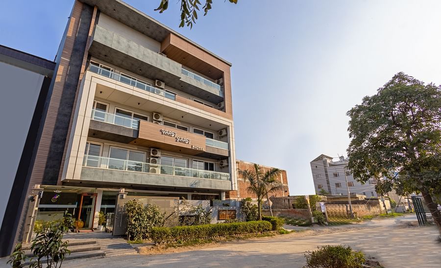 Modern exterior of Hotel Bawa, Gurgaon, with sleek architecture against a clear blue sky.