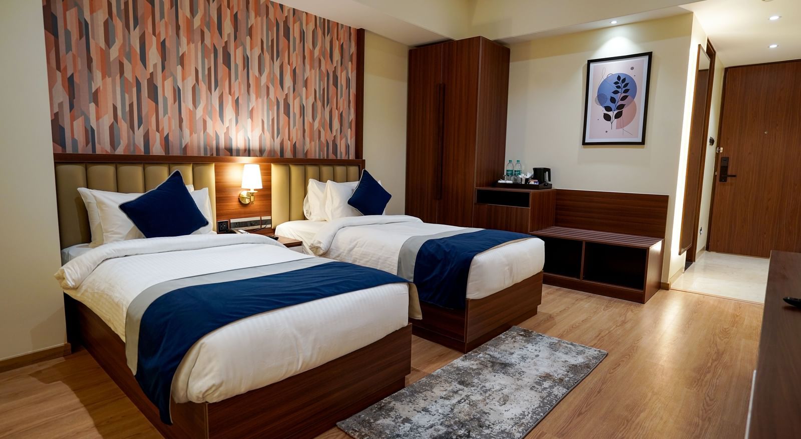 Corner view of the Superior Twin Bed Room with 2 single beds along with a rug in front of it at M2 Square by Monday Premium.
