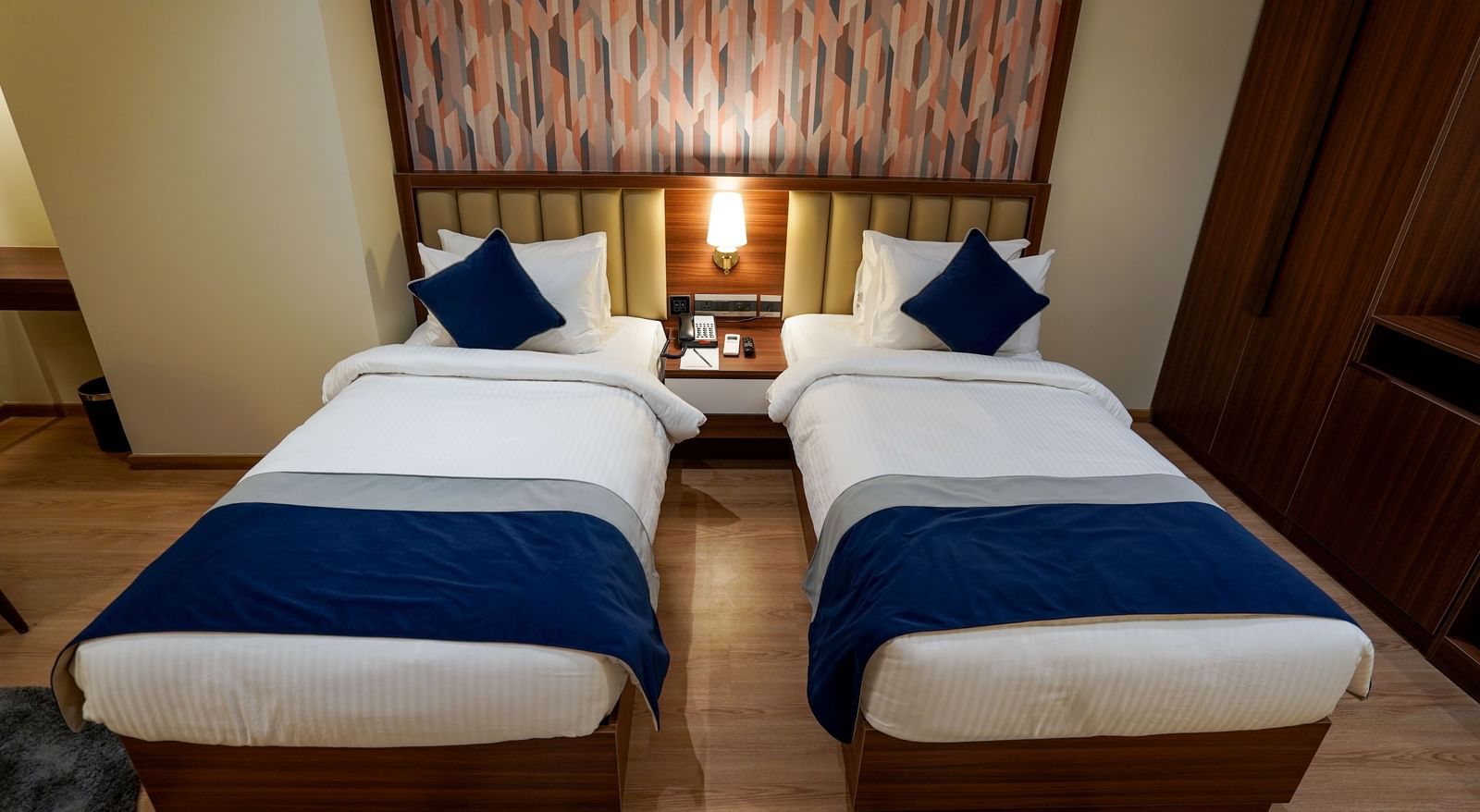 Top angle shot of the twin beds along with a bed side table in the middle at the Superior Twin Bed Room at M2 Square by Monday Premium.